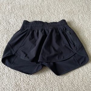 Lululemon Tracker short low-rise 4 in. Color is black.